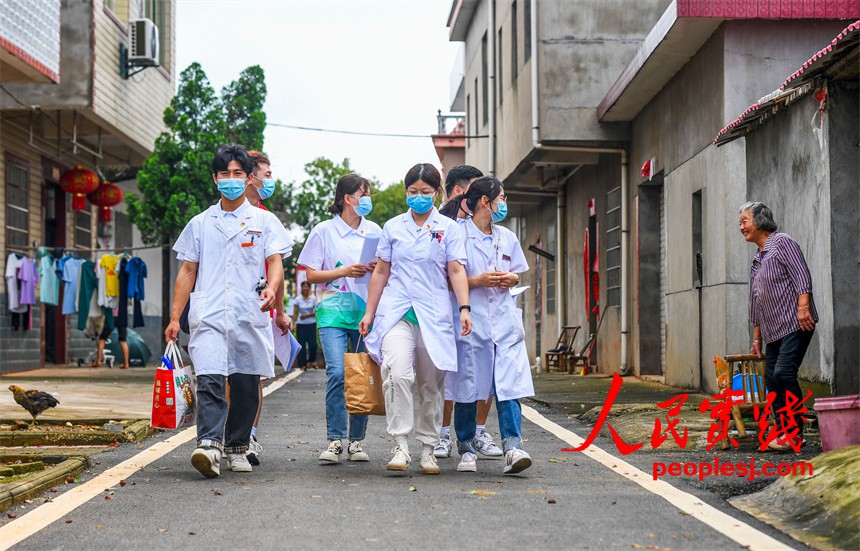 大学生们在樟树市观上镇定安村为村民免费义诊和宣讲卫生健康知识。周亮摄
